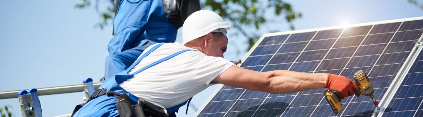 Solar worker installing panel